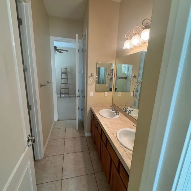 Outdated Bathroom With Tile Counters And Cheap Fixtures